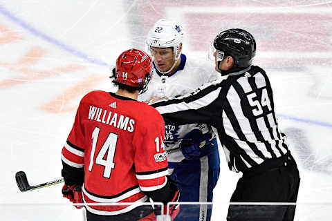 RALEIGH, NC – NOVEMBER 24: Linesman Greg Devosrki #54 separates Justin Williams #14 of the Carolina Hurricanes and Nikita Zaitsev #22 of the Toronto Maple Leafs during their game at PNC Arena on November 24, 2017 in Raleigh, North Carolina. Toronto won 5-4. (Photo by Grant Halverson/Getty Images)