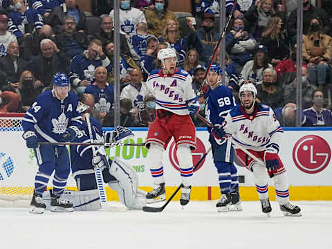 Oct 18, 2021; Toronto, Ontario, CAN; New York Rangers forward Artemi Panarin (10) celebrates his overtime winning goal as forward Mika Zibanejad (93) and Toronto Maple Leafs defenseman Morgan Rielly (44) and forward Michael Bunting (58) look on at Scotiabank Arena. Mandatory Credit: John E. Sokolowski-USA TODAY Sports