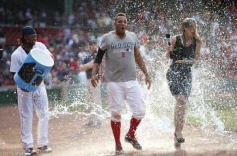 Jun 23, 2016; Boston, MA, USA; Boston Red Sox shortstop Xander Bogaerts (2) and NESN reporter Guerin Austin get drenched with Gatorade thrown by first baseman Hanley Ramirez (13) after Bogaerts hit a single to drive in the winning run during the tenth inning against the Chicago White Sox at Fenway Park. The Boston Red Sox won 8-7.. Mandatory Credit: Greg M. Cooper-USA TODAY Sports