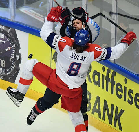 Libor Sulak of the Czech Republic with Dylan Larkin of the United States (Photo by Joe Klamar/AFP/Getty Images)