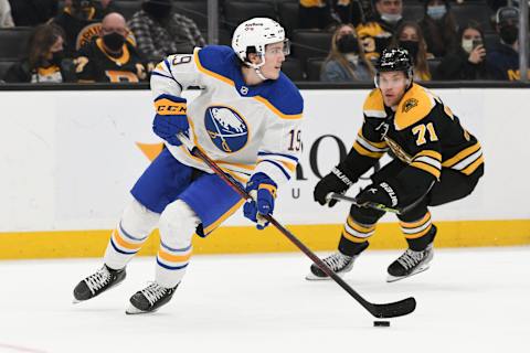 Jan 1, 2022; Boston, Massachusetts, USA; Buffalo Sabres center Peyton Krebs (19) controls the puck in front of Boston Bruins left wing Taylor Hall (71) during the third period at TD Garden. Mandatory Credit: Brian Fluharty-USA TODAY Sports