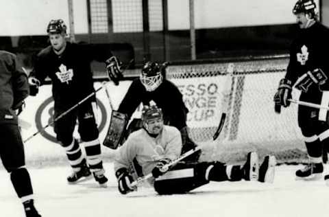 CANADA – DECEMBER 30: Mixing it up: Among the Leafs milling around the goal during yesterday’s practice are a sprawling Wendel Clark; Bob McGill at left; and Terry Johnson at right. Coach John Brophy has had to do considerable lineup juggling to get Leafs ready for Winnipeg Jets and his first confrontation with former boss Dan Maloney; who became Jets coach after contract negotiations with Leafs fizzled. (Photo by Colin McConnell/Toronto Star via Getty Images)