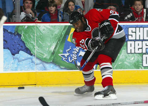 BUFFALO, NY – NOVEMBER 25: Mike Grier #25 of the Buffalo Sabres passes the puck during the game against the Montreal Canadiens on November 25, 2005 at HSBC Arena in Buffalo, New York. The Sabres won 3-1.(Photo by Rick Stewart/Getty Images)