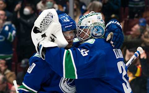 VANCOUVER, BC – APRIL 14: Goalie Thatcher Demko #35 of the Vancouver Canucks is congratulated by teammate Elias Pettersson #40 after defeating the Phoenix Coyotes 7-1 in NHL action on April 14, 2022 at Rogers Arena in Vancouver, British Columbia, Canada. (Photo by Rich Lam/Getty Images)