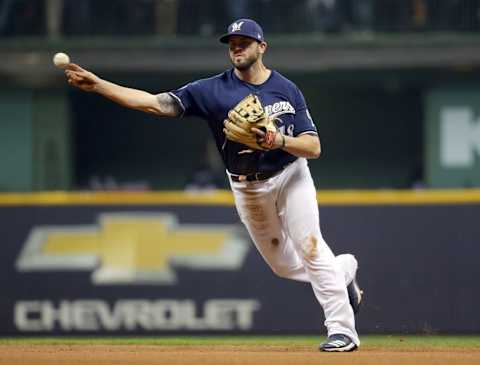 MILWAUKEE, WI – OCTOBER 12: Mike Moustakas #18 of the Milwaukee Brewers throws to first for the first out of the ninth inning in Game 1 of the NLCS against the Los Angeles Dodgers at Miller Park on Friday, October 12, 2018 in Milwaukee, Wisconsin. (Photo by Alex Trautwig/MLB Photos via Getty Images)