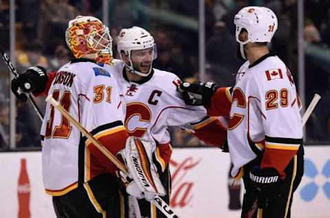 Nov 25, 2016; Boston, MA, USA; Calgary Flames goalie Chad Johnson (31) defenseman Mark Giordano (5) and defenseman Deryk Engelland (29) celebrate after defeating the Boston Bruins at TD Garden. Mandatory Credit: Bob DeChiara-USA TODAY Sports