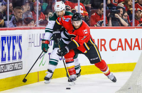 Feb 1, 2017; Calgary, Alberta, CAN; Calgary Flames defenseman TJ Brodie (7) and Minnesota Wild right wing Jason Pominville (29) battle for the puck during the first period at Scotiabank Saddledome. Mandatory Credit: Sergei Belski-USA TODAY Sports