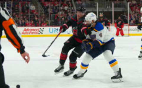 Feb 21, 2023; Raleigh, North Carolina, USA; Carolina Hurricanes right wing Andrei Svechnikov (37) and St. Louis Blues defenseman Nick Leddy (4) chase after the puck during the first period at PNC Arena. Mandatory Credit: James Guillory-USA TODAY Sports