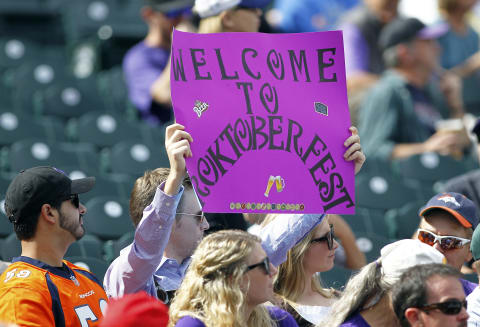 DENVER, CO – OCTOBER 01: A Rockies fan holds up a sign about the post season prior to a regular season MLB game between the Colorado Rockies and the visiting Los Angeles Dodgers at Coors Field on October 1, 2017 in Denver, Colorado. (Photo by Russell Lansford/Getty Images)