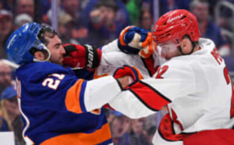 Apr 21, 2023; Elmont, New York, USA; New York Islanders center Kyle Palmieri (21) and Carolina Hurricanes defenseman Brett Pesce (22) fight during the second period in game three of the first round of the 2023 Stanley Cup Playoffs at UBS Arena. Mandatory Credit: Dennis Schneidler-USA TODAY Sports