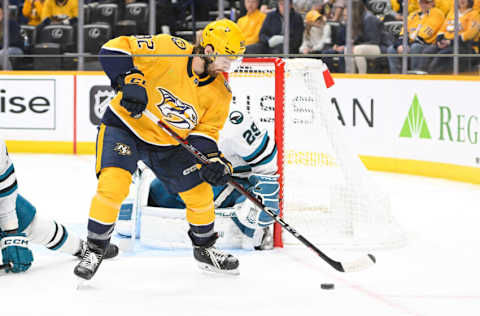 Oct 21, 2023; Nashville, Tennessee, USA; Nashville Predators center Tommy Novak (82) takes a shot on goal against the San Jose Sharks during the third period at Bridgestone Arena. Mandatory Credit: Steve Roberts-USA TODAY Sports