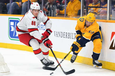 Feb 18, 2020; Nashville, Tennessee, USA; Nashville Predators defenseman Roman Josi (59) tries to pass the puck as he is pressured by Carolina Hurricanes center Martin Necas (88) during the first period at Bridgestone Arena. Mandatory Credit: Christopher Hanewinckel-USA TODAY Sports