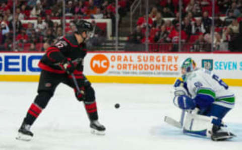 Jan 15, 2023; Raleigh, North Carolina, USA; Carolina Hurricanes center Jesperi Kotkaniemi (82) misses on his shot attempt on Vancouver Canucks goaltender Collin Delia (60) during the third period at PNC Arena. Mandatory Credit: James Guillory-USA TODAY Sports