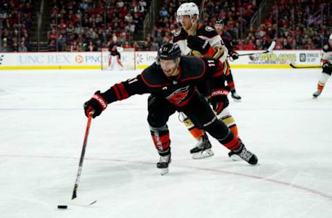 RALEIGH, NC – JANUARY 17: Jordan Staal #11 of the Carolina Hurricanes pokes the puck to keep it deep in the zone during an NHL game against the Anaheim Ducks on January 17, 2020 at PNC Arena in Raleigh, North Carolina. (Photo by Gregg Forwerck/NHLI via Getty Images)