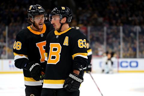 BOSTON, MASSACHUSETTS – NOVEMBER 29: David Pastrnak #88 of the Boston Bruins and Brad Marchand #63 talk during the third period against the New York Rangers at TD Garden on November 29, 2019 in Boston, Massachusetts. (Photo by Maddie Meyer/Getty Images)