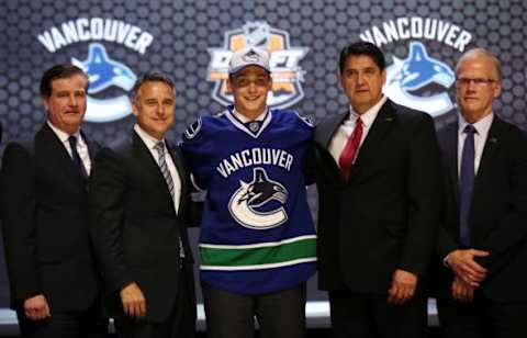 Jun 27, 2014; Philadelphia, PA, USA; Jake Virtanen poses for a photo with team officials after being selected as the number six overall pick to the Vancouver Canucks in the first round of the 2014 NHL Draft at Wells Fargo Center. Mandatory Credit: Bill Streicher-USA TODAY Sports