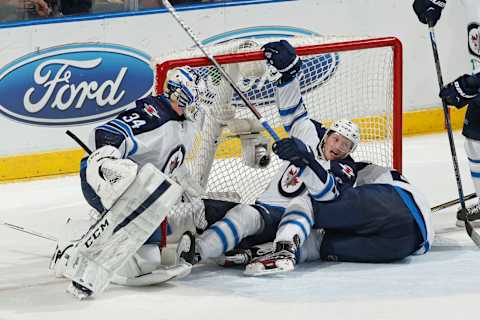 SUNRISE, FL – FEBRUARY 20: Goaltender Michael Hutchinson #34 moves to the side as Jacob Trouba #8 and Tyler Myers #57 of the Winnipeg Jets slide into the net during third period action against the Florida Panthers at the BB&T Center on February 20, 2016 in Sunrise, Florida. The Panthers defeated the Jets 3-1. (Photo by Joel Auerbach/Getty Images)