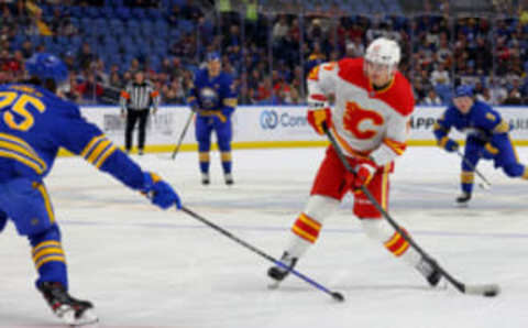 Oct 19, 2023; Buffalo, New York, USA; Buffalo Sabres defenseman Owen Power (25) tries to block a shot by Calgary Flames center Yegor Sharangovich (17) during the first period at KeyBank Center. Mandatory Credit: Timothy T. Ludwig-USA TODAY Sports