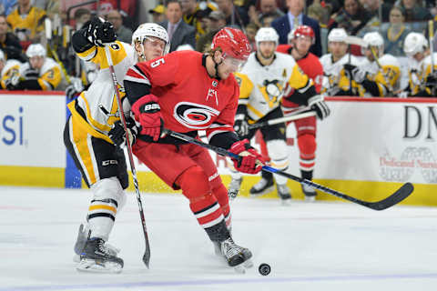 RALEIGH, NC – FEBRUARY 23: Pittsburgh Penguins Left Wing Jake Guentzel (59) attempts to fight through Carolina Hurricanes Defenceman Noah Hanifin (5) for a puck during a game between the Pittsburgh Penguins and the Carolina Hurricanes at the PNC Arena in Raleigh, NC on February 23, 2018. Pittsburgh defeated Carolina 6-1. (Photo by Greg Thompson/Icon Sportswire via Getty Images)