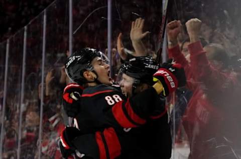 RALEIGH, NC – JANUARY 3: Ryan Dzingel #18 of the Carolina Hurricanes scores a goal and celebrates with teammate Martin Necas #88 during an NHL game against the Washington Capitals on January 3, 2020, at PNC Arena in Raleigh, North Carolina. (Photo by Gregg Forwerck/NHLI via Getty Images)