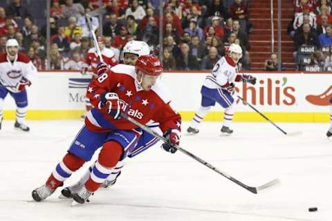 Feb 24, 2016; Washington, DC, USA; Washington Capitals defenseman Nate Schmidt (88) and Montreal Canadiens right wing Devante Smith-Pelly (21) battle for the puck in the third period at Verizon Center. The Canadiens won 4-3. Mandatory Credit: Geoff Burke-USA TODAY Sports