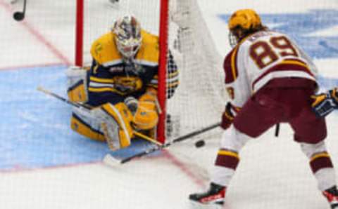 Apr 8, 2023; Tampa, Florida, USA; Quinnipiac goaltender Yaniv Perets (1) makes a save against Minnesota forward Matthew Knies (89) in the first period during the national championship game of the 2023 Frozen Four college ice hockey tournament at Amalie Arena. Mandatory Credit: Nathan Ray Seebeck-USA TODAY Sports