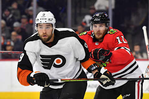 Jan 19, 2023; Philadelphia, Pennsylvania, USA; Philadelphia Flyers defenseman Ivan Provorov (9) and Chicago Blackhawks right wing Taylor Raddysh (11) battle for position during the second period at Wells Fargo Center. Mandatory Credit: Eric Hartline-USA TODAY Sports