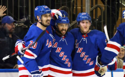 NEW YORK, NEW YORK – DECEMBER 12: Vincent Trocheck #16 of the New York Rangers (C) celebrates his powerplay goal against the New Jersey Devils at 13:58 of the second period and is joined by Chris Kreider #20 (L) and Adam Fox #23 (R) at Madison Square Garden on December 12, 2022, in New York City. (Photo by Bruce Bennett/Getty Images)