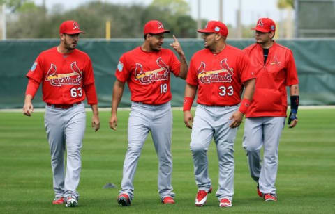 Feb 18, 2016; Jupiter, FL, USA; St. Louis Cardinals relief pitcher Miguel Socolovich (63) listens to starting pitcher Carlos Martinez (18) talk to relief pitcher Carlos Villanueva (33) as catcher Yadier Molina (4) listens in during warm up drills at Roger Dean Stadium. Mandatory Credit: Steve Mitchell-USA TODAY Sports