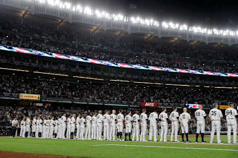 NEW YORK, NEW YORK – OCTOBER 03: The New York Yankees stand on the first base line prior to the American League Wild Card Game against the Oakland Athletics at Yankee Stadium on October 03, 2018 in the Bronx borough of New York City. (Photo by Elsa/Getty Images)