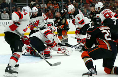 ANAHEIM, CALIFORNIA – DECEMBER 09: Cory Schneider #35 of the New Jersey Devils (C) makes a save against the Anaheim Ducks at Honda Center on December 09, 2018 in Anaheim, California. (Photo by Katharine Lotze/Getty Images)