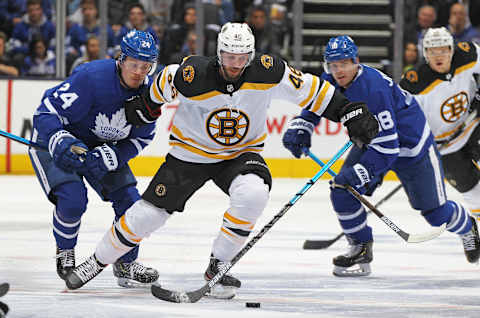 TORONTO, ON – APRIL 15: David Krejci #46 of the Boston Bruins skates between Kasperi Kapanen #24 and Andreas Johnsson #18 of the Toronto Maple Leafs. (Photo by Claus Andersen/Getty Images)