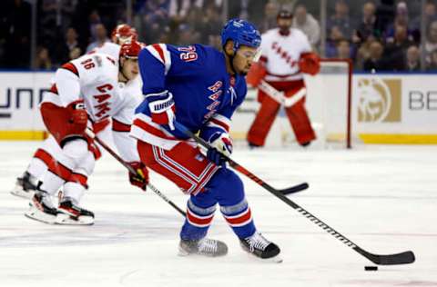 NEW YORK, NEW YORK – MARCH 21: K’Andre Miller, #79 of the New York Rangers, controls the puck during the third period against the Carolina Hurricanes at Madison Square Garden on March 21, 2023, in New York City. The Hurricanes won 3-2. (Photo by Sarah Stier/Getty Images)