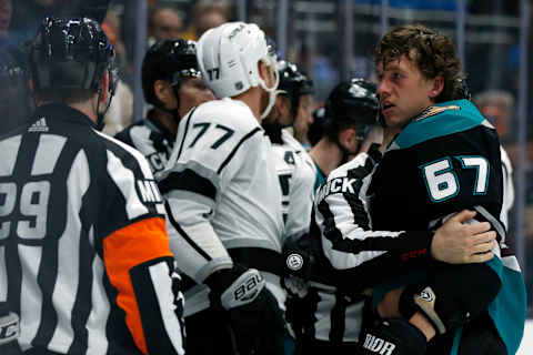 ANAHEIM, CALIFORNIA – MARCH 10: Rickard Rakell #67 of the Anaheim Ducks is pulled away by a referee following a fight with members of the Los Angeles Kings during a game at Honda Center on March 10, 2019 in Anaheim, California. (Photo by Katharine Lotze/Getty Images)