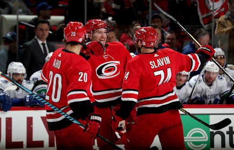 RALEIGH, NC – FEBRUARY 9: Brett Pesce #22 of the Carolina Hurricanes celebrates with teammates Jaccob Slavin #74 and Sebastian Aho #20 after scoring a goal during an NHL game against the Vancouver Canucks on February 9, 2018 at PNC Arena in Raleigh, North Carolina. (Photo by Gregg Forwerck/NHLI via Getty Images)