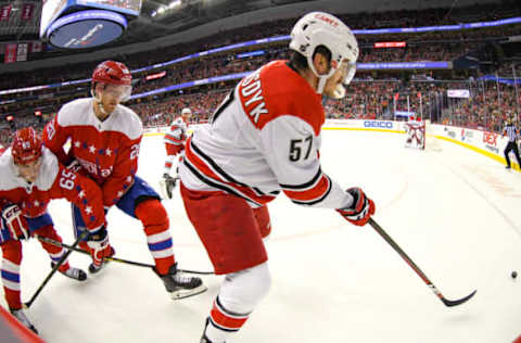 WASHINGTON, DC – DECEMBER 27: Carolina Hurricanes defenseman Trevor van Riemsdyk (57) works along the boards in the second period against Washington Capitals center Lars Eller (20) on December 27, 2018, at the Capital One Arena in Washington, D.C. (Photo by Mark Goldman/Icon Sportswire via Getty Images)