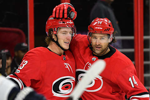 RALEIGH, NC – NOVEMBER 07: Carolina Hurricanes Right Wing Justin Williams (14) congratulates Carolina Hurricanes Right Wing Brock McGinn (23) after scoring a goal during a game between the Florida Panthers and the Carolina Hurricanes at the PNC Arena in Raleigh, NC on November 7 2017. Carolina defeated Florida 3-1. (Photo by Greg Thompson/Icon Sportswire via Getty Images)