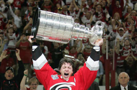 RALEIGH, NC – JUNE 19: Rod Brind’Amour #17 of the Carolina Hurricanes hoists the Stanley Cup after the Hurricanes defeated the Edmonton Oilers in game seven of the 2006 NHL Stanley Cup Finals on June 19, 2006 at the RBC Center in Raleigh, North Carolina. The Hurricanes defeated the Oilers 3-1 to win the series 4-3. (Photo by Jim McIsaac/Getty Images)