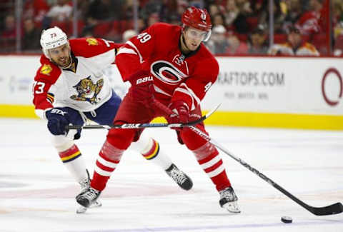 Dec 18, 2015; Raleigh, NC, USA; Carolina Hurricanes forward Victor Rask (49) skates with the puck against Florida Panthers forward Brandon Pirri (73) during the 3rd period at PNC Arena. The Florida Panthers defeated the Carolina Hurricanes 2-0. Mandatory Credit: James Guillory-USA TODAY Sports