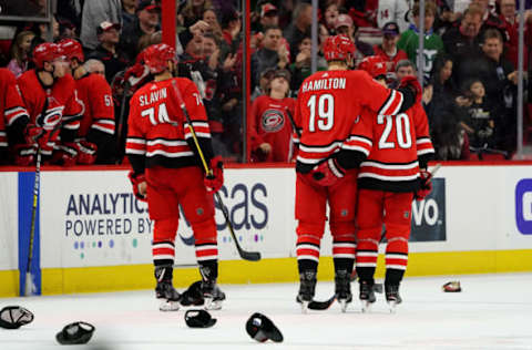 RALEIGH, NC – DECEMBER 07: Sebastian Aho #20 of the Carolina Hurricanes celebrates his hat trick goal with Dougie Hamilton #19 and teammates during an NHL game against the the Minnesota Wild on December 7, 2019 at PNC Arena in Raleigh, North Carolina. (Photo by Gregg Forwerck/NHLI via Getty Images)