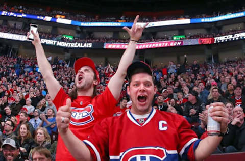 Apr 9, 2015; Montreal, Quebec, CAN; Two Montreal Canadiens fans cheer during the third period against Detroit Red Wings at Bell Centre. Mandatory Credit: Jean-Yves Ahern-USA TODAY Sports