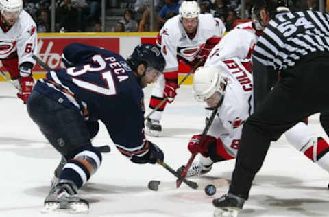 EDMONTON, AB – JUNE 12: Michael Peca #37 of the Edmonton Oilers faces off against Matt Cullen #8 of the Carolina Hurricanes in game four of the 2006 NHL Stanley Cup Finals on June 12, 2006, at Rexall Place in Edmonton, Alberta, Canada. The Hurricanes defeated the Oilers 2-1 to take a 3-1 game series lead. (Photo by Dave Sandford/Getty Images)