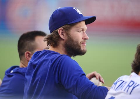 Jul 20, 2021; Los Angeles, California, USA; Los Angeles Dodgers pitcher Clayton Kershaw (22) watches game action against the San Francisco Giants during the first inning at Dodger Stadium. Mandatory Credit: Gary A. Vasquez-USA TODAY Sports