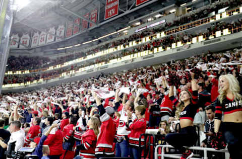 RALEIGH, NC – MAY 03: Carolina Hurricanes fans celebrate a goal in Game Four of the Eastern Conference Second Round against the New York Islanders during the 2019 NHL Stanley Cup Playoffs on May 3, 2019 at PNC Arena in Raleigh, North Carolina. (Photo by Gregg Forwerck/NHLI via Getty Images)