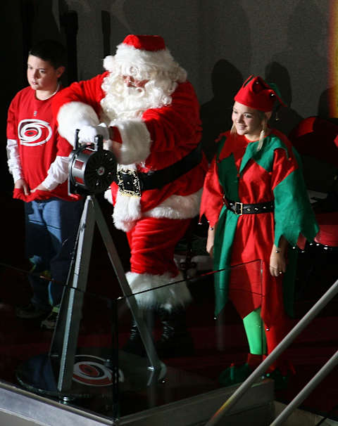 RALEIGH, NC – DECEMBER 23: Santa Claus sounds the Hurricane warning siren prior to a NHL game between the Carolina Hurricanes and the Montreal Canadiens on December 23, 2009 at RBC Center in Raleigh, North Carolina. (Photo by Gregg Forwerck/NHLI via Getty Images)