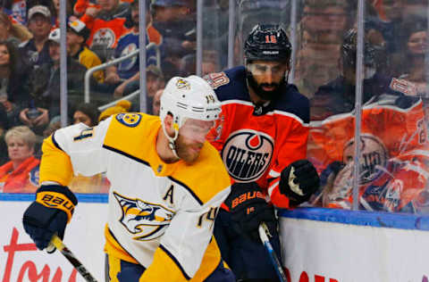 Oct 20, 2018; Edmonton, Alberta, CAN; Nashville Predators defensemen Mattias Ekholm (14) avoids a check from Edmonton Oilers forward Jujhar Khaira (16). Mandatory Credit: Perry Nelson-USA TODAY Sports