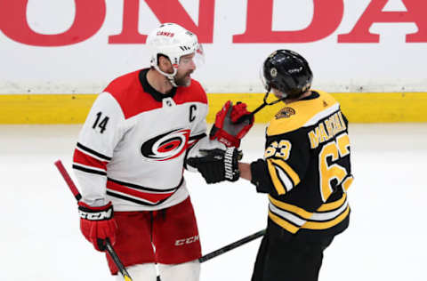 MAY 12: Justin Williams #14 of the Carolina Hurricanes pulls on the chinstrap of Brad Marchand #63 of the Boston Bruins (Photo by Adam Glanzman/Getty Images)