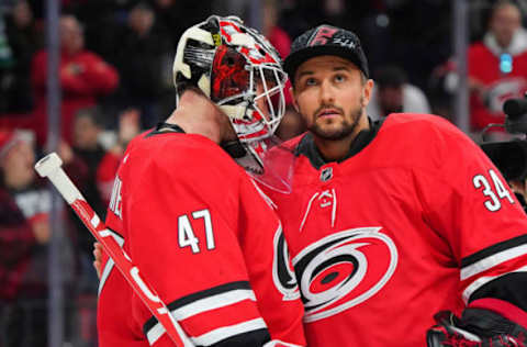 Feb 2, 2020; Raleigh, North Carolina, USA; Carolina Hurricanes goaltender James Reimer (47) and Carolina Hurricanes goaltender Petr Mrazek (34) celebrate their win against the Vancouver Canucks at PNC Arena. the Carolina Hurricanes defeated the Vancouver Canucks 4-3 in the shootout. Mandatory Credit: James Guillory-USA TODAY Sports