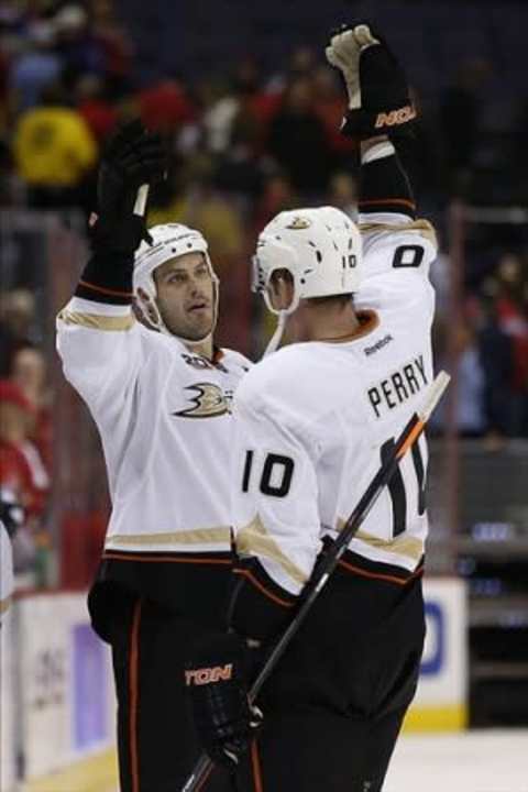 Dec 23, 2013; Washington, DC, USA; Anaheim Ducks center Ryan Getzlaf (15) celebrates with Ducks right wing Corey Perry (10) after winning 3-2 against the Washington Capitals at Verizon Center. Mandatory Credit: Geoff Burke-USA TODAY Sports