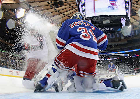 NEW YORK, NEW YORK – JANUARY 19: Pierre-Luc Dubois #18 of the Columbus Blue Jackets slides into Igor Shesterkin #31 of the New York Rangers during the second period at Madison Square Garden on January 19, 2020 in New York City. The Blue Jackets defeated the Rangers 2-1. (Photo by Bruce Bennett/Getty Images)